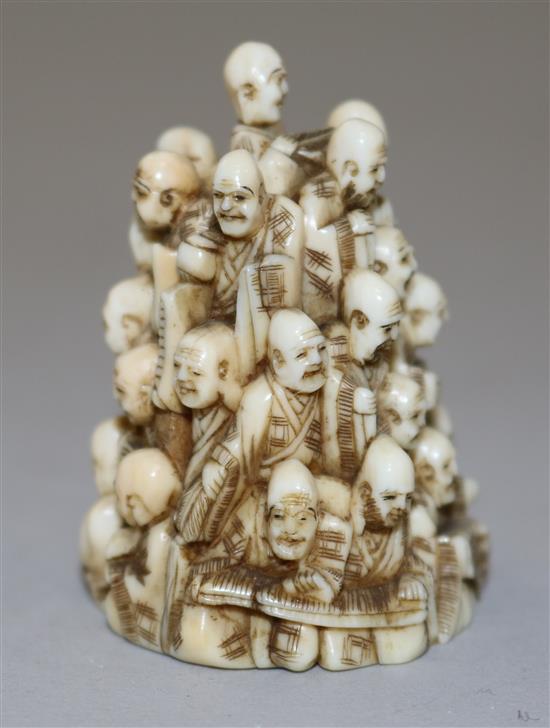 A Japanese ivory netsuke of multiple rakan, Meiji period, height 5.6cm